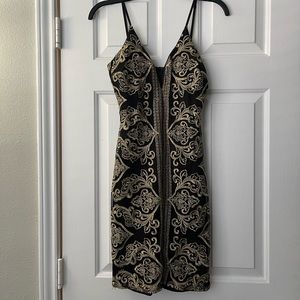 Black mini dress with gold accents!